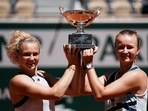 Czech Republic's Barbora Krejcikova, right, and compatriot Katerina Siniakova hold the cup after defeating USA's Bethanie Mattek-Sands and Poland's Iga Swiatek in their women's doubles final match of the French Open.(AP) Czech Republic's Barbora Krejcikova, right, and compatriot Katerina Siniakova hold the cup after defeating USA's Bethanie Mattek-Sands and Poland's Iga Swiatek in their women's doubles final match of the French Open.(AP)