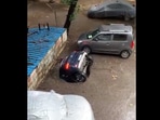 The image is a screengrab of the viral video showing the sinking car in Mumbai's Ghatkopar area.(ANI) The image is a screengrab of the viral video showing the sinking car in Mumbai's Ghatkopar area.(ANI)