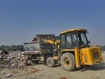 South Delhi Municipal Corporation (SMCD) truck loads garbage, near Kalindi Kunj.