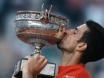 Sweet victory. Champion Novak Djokovic celebrates with La Coupe des Mousquetaires.(AP)
