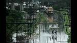 Commuters wade through submerged railway tracks while a local train is stranded due to heavy rains, Mumbai, June 12, 2021 (Pratik Chorge/HT PHOTO) Commuters wade through submerged railway tracks while a local train is stranded due to heavy rains, Mumbai, June 12, 2021 (Pratik Chorge/HT PHOTO)