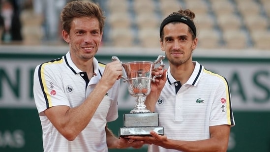 France's Pierre-Hugues Herbert and Nicolas Mahut celebrate with the trophy(REUTERS)