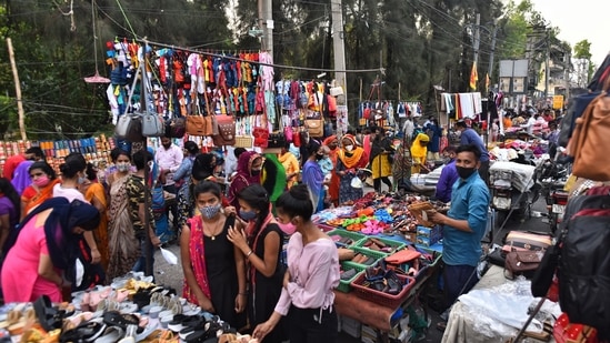 A rush of people shopping in a weekly market at Kingsway Camp, in New Delhi.