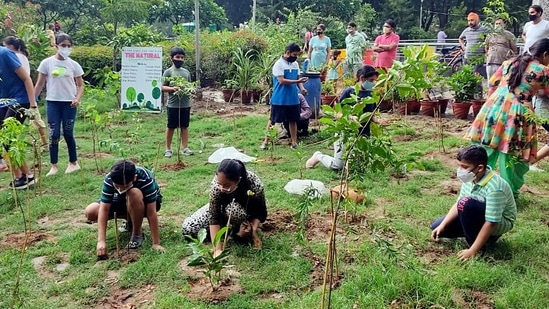 Children create a micro oxygen chamber by planting 750 tree saplings in Ludhiana on Sunday. (ANI )