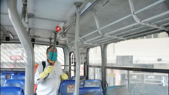 A bus being sanitised in Mandi on Sunday. (Birbal Sharma/HT)