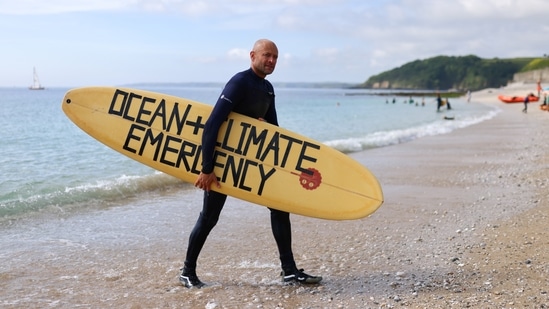 Hugo Tagholm, Chief Executive of the marine conservation and campaigning charity Surfers Against Sewage, poses for a photo, in Gyllyngvase beach, Falmouth, on the sidelines of G7 summit in Cornwall on June 12. The G7 is due to discuss action on climate change and safeguarding global biodiversity on June 13, laying the groundwork for the UN's pivotal COP26 environmental summit in Scotland in November.(Tom Nicholson / REUTERS)