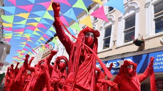 Activists from The Red Brigade attending an Extinction Rebellion demonstration in Falmouth, during the G7 summit in Cornwall. The leaders of the G7 are expected to debate a pledge at the summit to protect at least 30 percent of the world's land and oceans by 2030.(Tom Nicholson / REUTERS)
