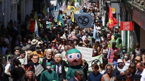 Protestors march during an Extinction Rebellion demonstration in Falmouth, during the G7 summit in Cornwall on June 12. On June 11, the G7 heads of state had met business leaders to discuss ramping up sustainability efforts, at a reception hosted by Queen Elizabeth II and her son Prince Charles at Cornwall's Eden Project, a renowned attraction showcasing the world's ecological riches.(Tom Nicholson / REUTERS)