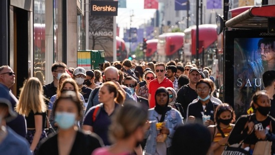 Pedestrians, some wearing face coverings due to Covid-19, walk past shops on Oxford Street in central London.(AFP) Pedestrians, some wearing face coverings due to Covid-19, walk past shops on Oxford Street in central London.(AFP)