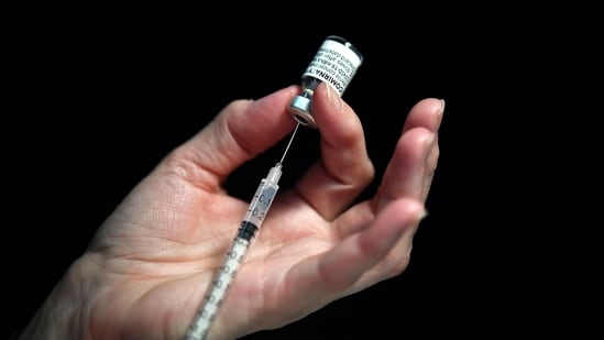 A nurse preparing a syringe of the Covid-19 vaccine at a vaccination centre.(AFP)