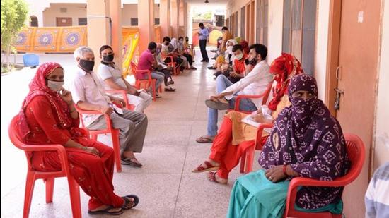 People waiting to get vaccinated against Covid at a health centre in Haryana. (HT Photo) People waiting to get vaccinated against Covid at a health centre in Haryana. (HT Photo)