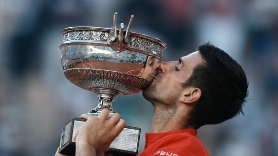 Sweet victory. Champion Novak Djokovic celebrates with La Coupe des Mousquetaires.(AP)