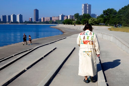 Dan O'Conor, wearing a "Great Lake Jumper" robe walks down the slope to make his 364th leap into Lake Michigan.(AP) Dan O'Conor, wearing a "Great Lake Jumper" robe walks down the slope to make his 364th leap into Lake Michigan.(AP)