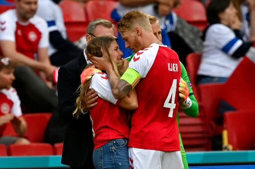 Simon Kjaer consoles Christian Eriksen's wife after the footballer collapsed on the pitch midway during Euro 2020 match between Denmark and Finland.&nbsp;(AP)