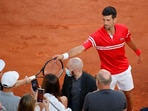 Tennis - French Open - Roland Garros, Paris, France - June 13, 2021 Serbia's Novak Djokovic gives his racket to a fan after winning the final against Greece's Stefanos Tsitsipas.(REUTERS)