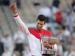 Serbia's Novak Djokovic celebrates with the trophy after winning the French Open against Greece's Stefanos Tsitsipas