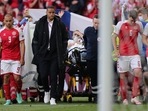 Denmark's players escort Denmark's midfielder Christian Eriksen (C) as he is evacuated after collapsing on the pitch during the UEFA EURO 2020 Group B football match between Denmark and Finland. (AFP) Denmark's players escort Denmark's midfielder Christian Eriksen (C) as he is evacuated after collapsing on the pitch during the UEFA EURO 2020 Group B football match between Denmark and Finland. (AFP)