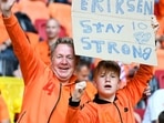 Two Netherlands fans hold a sign supporting Denmark's midfielder Christian Eriksen before the UEFA EURO 2020 Group C football match between the Netherlands and Ukraine at the Johan Cruyff Arena in Amsterdam. Eriksen was fan favourite at the stadium during his time with Dutch club Ajax Amsterdam.(AFP) Two Netherlands fans hold a sign supporting Denmark's midfielder Christian Eriksen before the UEFA EURO 2020 Group C football match between the Netherlands and Ukraine at the Johan Cruyff Arena in Amsterdam. Eriksen was fan favourite at the stadium during his time with Dutch club Ajax Amsterdam.(AFP)