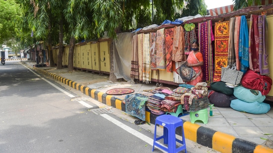 Goods lined at a roadside stall at a Gujarati handicraft market in Janpath, in New Delhi, on June 13. Swimming pools, gyms, spas and public parks and gardens will remain closed.(Manvender Vashist / PTI)