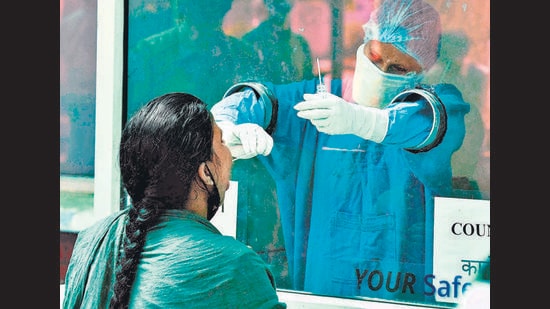 A health worker collects a swab sample for Covid testing at Sector 16 in Chandigarh on Monday. (KESHAV SINGH/HT) A health worker collects a swab sample for Covid testing at Sector 16 in Chandigarh on Monday. (KESHAV SINGH/HT)