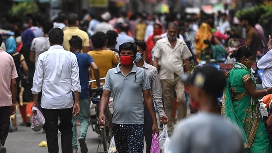 People shop at a market after the government eased restrictions as the number of new Covid-19 coronavirus infections dropped, in Gurgaon. (AFP)
