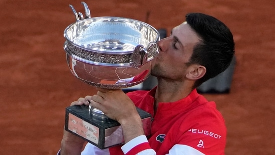 Novak Djokovic kisses the cup after defeating Stefanos Tsitsipas of Greece during their final match of the French Open tennis tournament at the Roland Garros stadium. (AP) Novak Djokovic kisses the cup after defeating Stefanos Tsitsipas of Greece during their final match of the French Open tennis tournament at the Roland Garros stadium. (AP)
