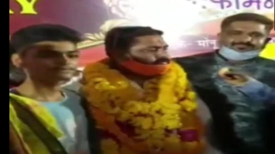 BJP Yuva Morcha district president Mridul Dwivedi along with his guests were seen without masks in public and was not following the social distancing norms.(ANI Photo) BJP Yuva Morcha district president Mridul Dwivedi along with his guests were seen without masks in public and was not following the social distancing norms.(ANI Photo)