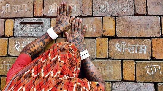 A devotee prays to the bricks expected to be used in construction of the Ram temple, in Ayodhya.(AP) A devotee prays to the bricks expected to be used in construction of the Ram temple, in Ayodhya.(AP)