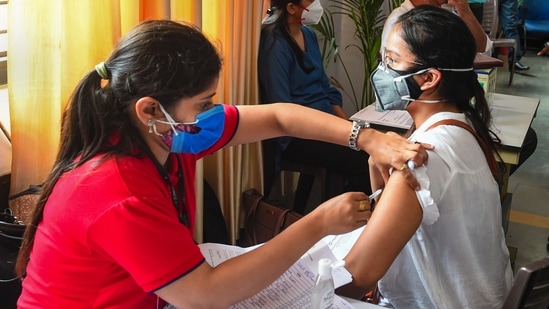 A healthcare worker administers Covid-19 vaccine dose to a student at a vaccination centre, in New Delhi on Monday.(PTI Photo) A healthcare worker administers Covid-19 vaccine dose to a student at a vaccination centre, in New Delhi on Monday.(PTI Photo)