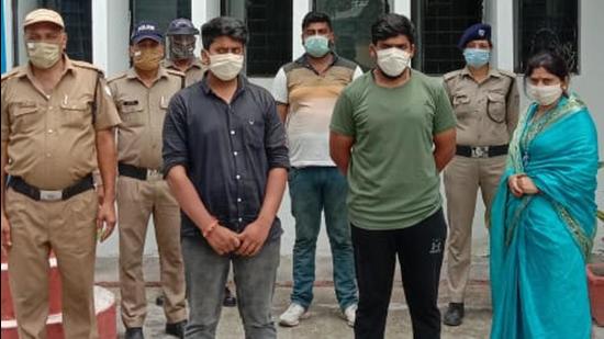 Arrested BJP leader (in blue sari) with her sons and aide at Clement Town police station in Dehradun. HT Photo Arrested BJP leader (in blue sari) with her sons and aide at Clement Town police station in Dehradun. HT Photo
