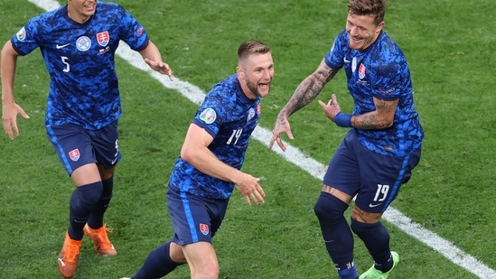 Slovakia's Milan Skriniar, centre, celebrates after scoring his side's second goal.(AP)