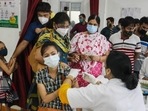 A health worker administers a dose of Covid-19 vaccine to a woman. (PTI) A health worker administers a dose of Covid-19 vaccine to a woman. (PTI)