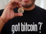 Bitcoin enthusiast Carlos Bonilla shows a physical coin at a Bitcoin beach support office at El Zonte Beach in Chiltiupan.(Reuters)