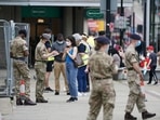 Members of the armed forces speak to people, outside a mobile Covid-19 vaccination centre, in Bolton, England. Members of the armed forces speak to people, outside a mobile Covid-19 vaccination centre, in Bolton, England.