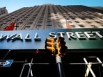 A sign for a Wall Street building is shown, (AP file photo) A sign for a Wall Street building is shown, (AP file photo)