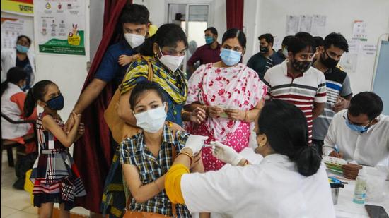 A health worker administers a dose of Covid-19 vaccine to a woman at a railway hospital in Prayagraj on Monday, June 14. (PTI)