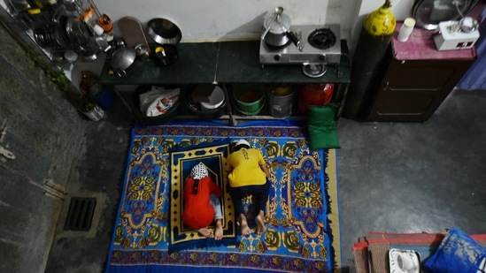Two of the three siblings offer prayers at their house in New Delhi on May 5. "They are my sister's children and I love them. I want to ensure they get an education and have a bright future, but there is only so much that I can do,” Mohammad Asif, who also has to take care of his seven-month pregnant wife, told PTI. He added, "I do not earn enough to fend for three children. I want the best for them, but I will need help."(Arun Sharma / PTI)