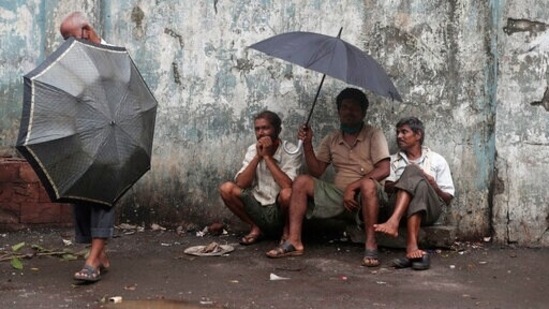 Workers wait to be employed for the day, on a street in Mumbai, India, Friday, June 11, 2021. (AP)