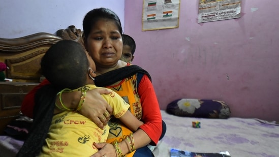 Madhu Gupta, along with her children, in an emotional state while speaking about her husband, who died of Covid-19 during the second wave of coronavirus, in New Delhi on May 9. "My younger son keeps asking about his father, and I do not have an answer. The little one was really close to him... the elder boy has become indifferent," Madhu told PTI, adding that "I don't know what to take care of. My children, their futures, or myself. I am so clueless and scared."(Arun Sharma / PTI)