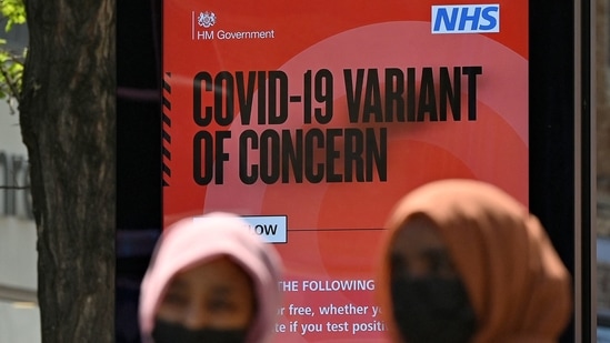 Pedestrians walk past a sign warning members of the public about a 'Coronavirus variant of concern' in Hounslow, west London, about the Delta variant of the coronavirus.(AFP Photo)