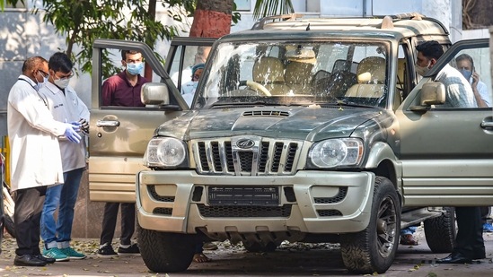 Pune's Forensic Science Laboratory (FSL) officials seen conducting an investigation on the SUV, seized near industrialist Mukesh Ambani's residence laden with explosives, at NIA office, in Mumbai in this file photo from March. (PTI Photo)