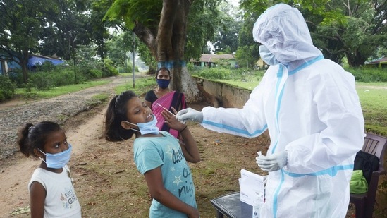 A health worker collects swab sample of a child for Covid-19 test, amid second wave of the pandemic, in Ranchi. (PTI) A health worker collects swab sample of a child for Covid-19 test, amid second wave of the pandemic, in Ranchi. (PTI)
