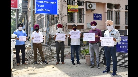 Members of NGOs protesting outside the Ludhiana Improvement Trust office at Feroze Gandhi Market in Ludhiana on Tuesday. (Harsimar Pal Singh/HT)