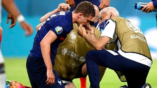 Benjamin Pavard took a hit while defending a cross from Joshua Kimmich. After a small pause and some treatment, he was back up.(AP)