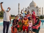 A man takes a selfie with his family at Taj Mahal that reopened after authorities eased restrictions in the ongoing Covid-19 lockdown, in Agra, on June 16.
