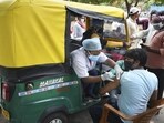 Health workers administer the Covid-19 vaccine to auto-rickshaw drivers outside the railway station in Ranchi, Jharkhand.(PTI)