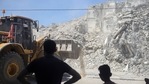Palestinians watch as an Egyptian team clears rubble from the destroyed Al-Shorouk Tower in Gaza City, Gaza, on Tuesday, June 15, 2021. (Bloomberg) Palestinians watch as an Egyptian team clears rubble from the destroyed Al-Shorouk Tower in Gaza City, Gaza, on Tuesday, June 15, 2021. (Bloomberg)