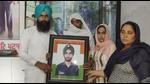 Gurbinder Singh’s family with his photo at their home in Tolowal village near Sunam in Sangrur. (HT Photo) Gurbinder Singh’s family with his photo at their home in Tolowal village near Sunam in Sangrur. (HT Photo)