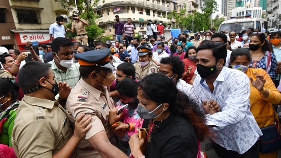 Police personnel tries to control the clash between Shiv Sena and BJP during a protest organized by BJP on the issue of Ram Mandir at Dadar, in Mumbai. (ANI Photo)