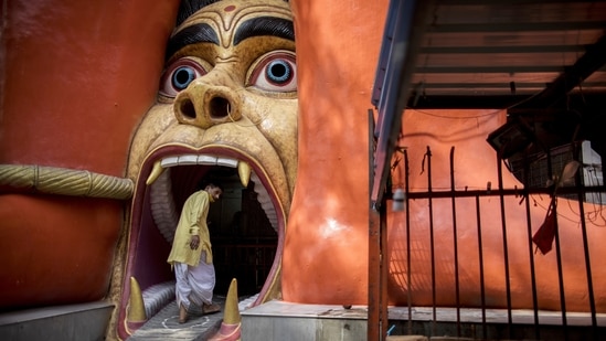 A priest enters the gate of a Hanuman Temple after lockdown restrictions were eased in New Delhi, on June 16.(Anindito Mukherjee / Bloomberg)